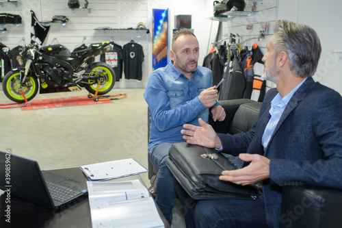 Wallpaper Mural customer listening to motorcycle salon manager Torontodigital.ca