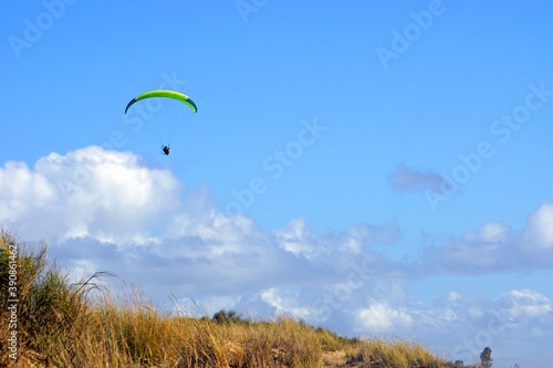 Paraglider over the sunny clouds