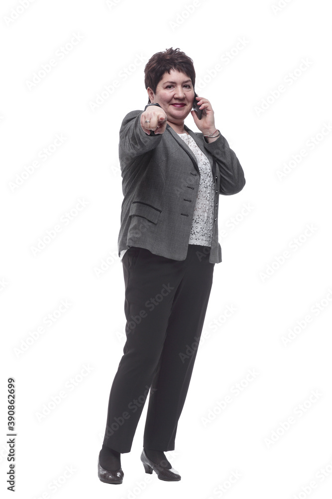 in full growth. successful mature woman talking on her smartphone in full growth. successful mature woman talking on her smartphone