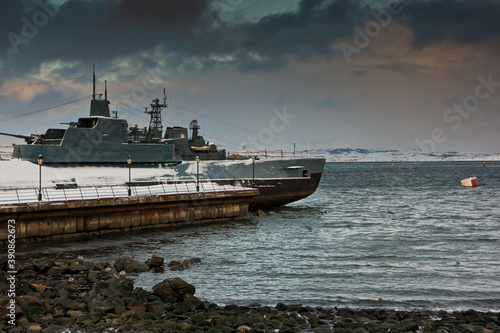 Soviet submarine as a monument moored in dock of Barents Sea in winter and clouds over it. photo