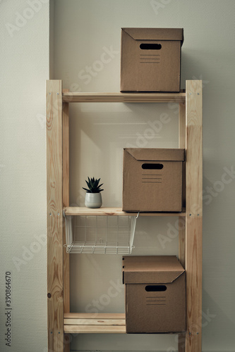 Paper boxes are on a wooden rack. Archive storage, use of eco-friendly materials