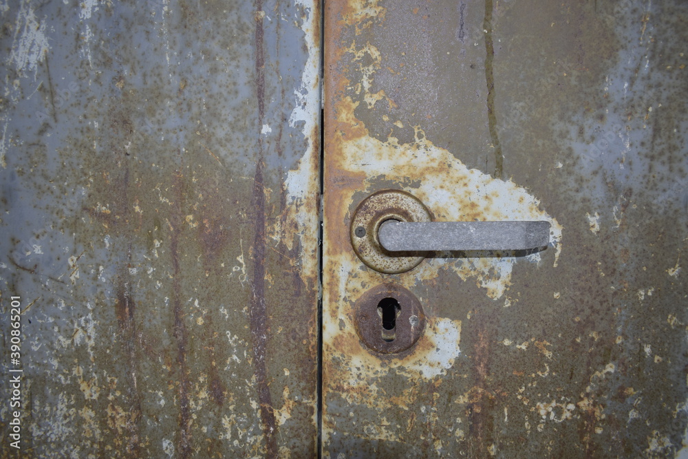 Old rusty texture of metal safe with a handle.