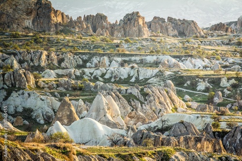 Volcanic rock formations in Cappadocia, Turkey.  Beautiful sunny summer day. This rocky wonderland was shaped by millions of years of natural phenomena. photo