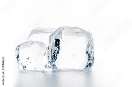Ice cubes on white surface, isolated on white.