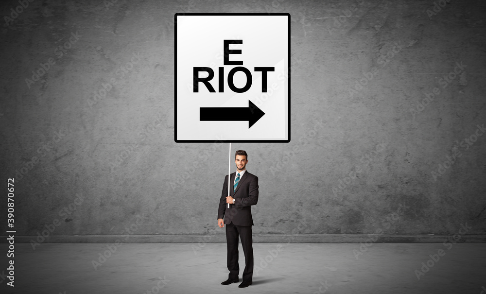 business person holding a traffic sign with E RIOT inscription, new idea concept business person holding a traffic sign with E RIOT inscription, new idea concept