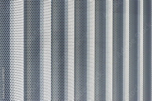 Background of white metal columns with evenly placed holes