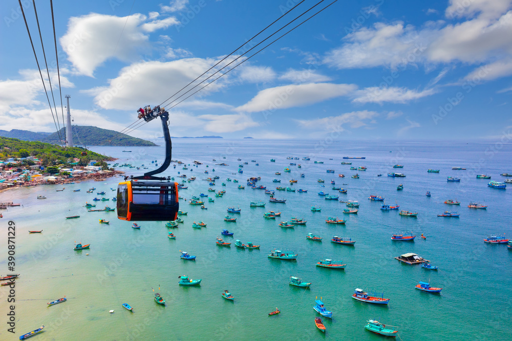 Hanging cabin on the Phu Quoc cable car to Hon Thom Island above azure sea. Top view of Vietnamese fishing boats in the turquoise sea on Phu Quoc island, Vietnam