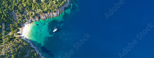 Aerial drone top down ultra wide photo of luxury yacht anchored in tropical exotic island turquoise sea © aerial-drone