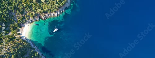 Obraz  z motywem Aerial drone top down ultra wide photo of luxury yacht anchored in tropical exotic island turquoise sea