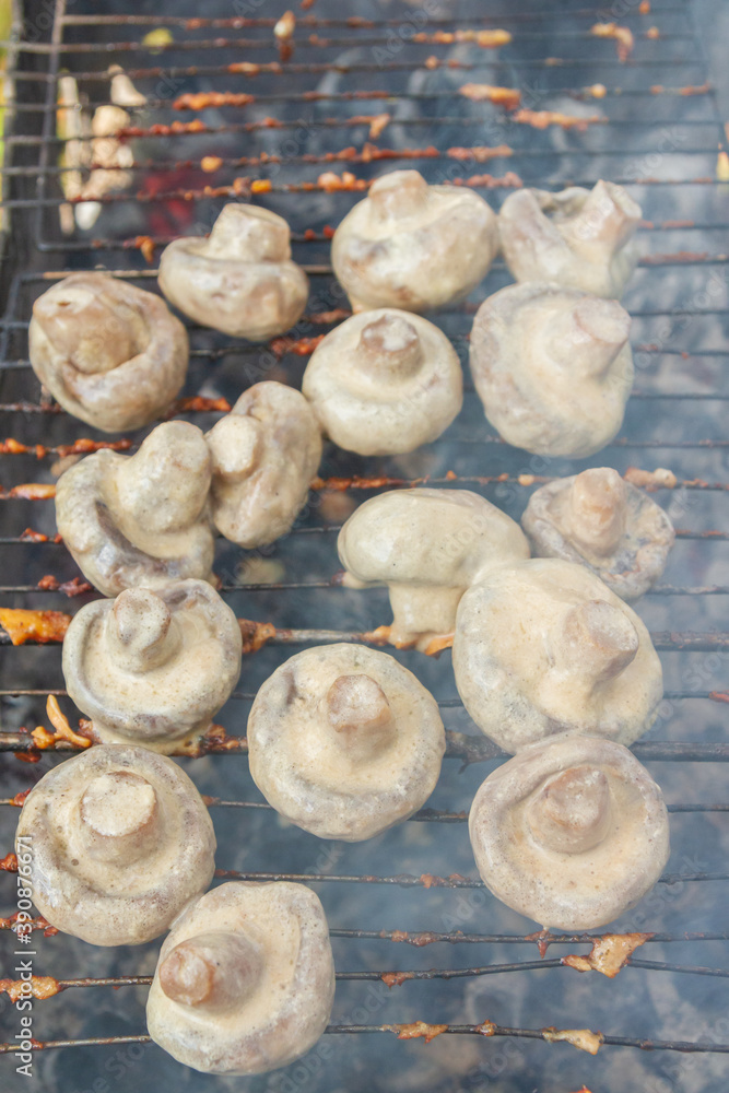 Pickled mushrooms are cooked on the grill on coals Pickled mushrooms are cooked on the grill on coals
