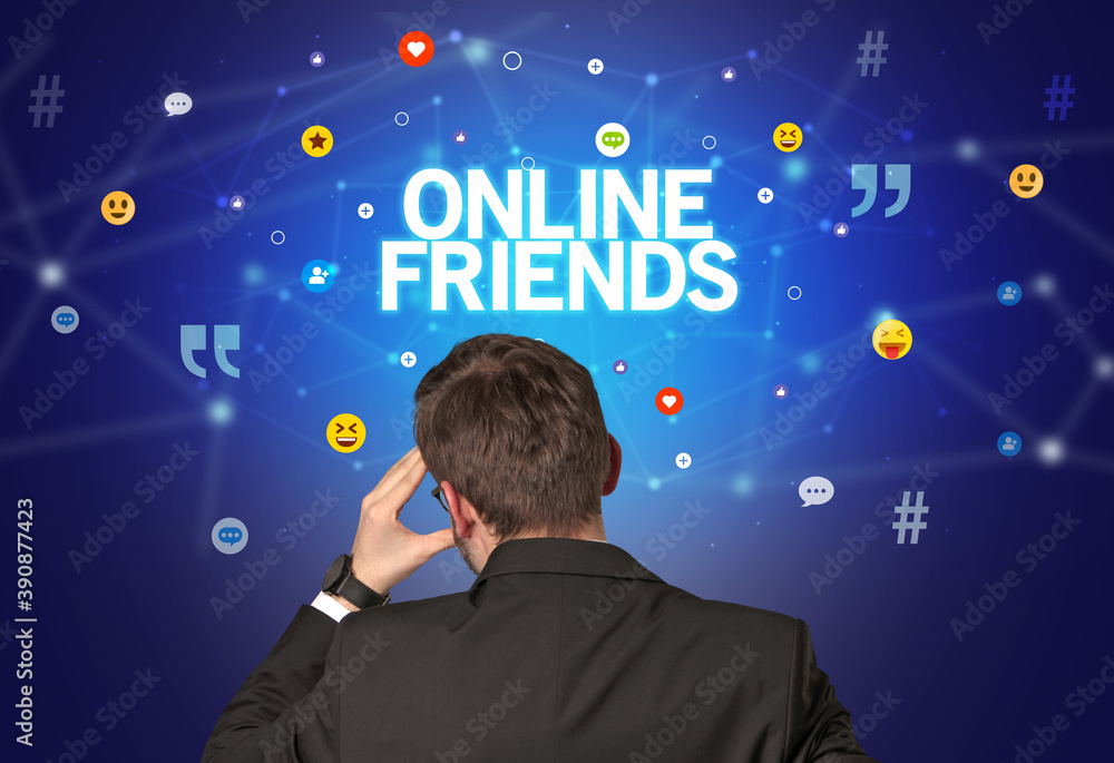 Rear view of a businessman with ONLINE FRIENDS inscription, social networking concept Rear view of a businessman with ONLINE FRIENDS inscription, social networking concept