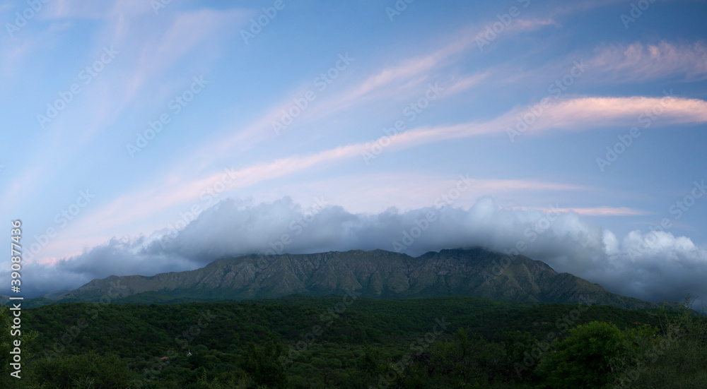 Magical view of popular landmark Uritorco hill, valley and green forest at sunset, in Capilla del Monte, Cordoba, Argentina. Magical view of popular landmark Uritorco hill, valley and green forest at sunset, in Capilla del Monte, Cordoba, Argentina.