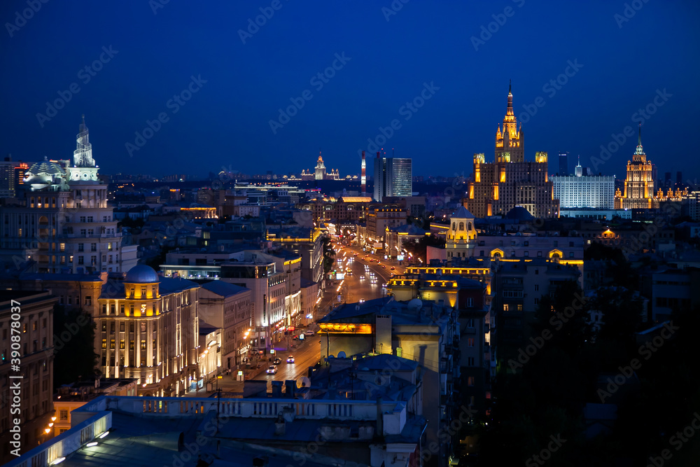 Panoramic photo. Evening or night illuminated building of Moscow Garden Ring on deep blue sky.