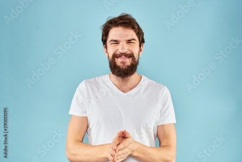 Emotional man with a beard in a white t-shirt blue background fun lifestyle © SHOTPRIME STUDIO