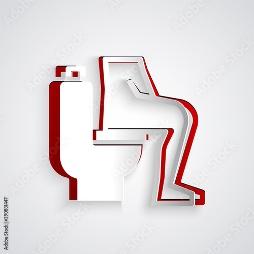 Paper cut Men sitting on the toilet and Constipation are experiencing severe abdominal pain icon isolated on grey background. Paper art style. Vector.