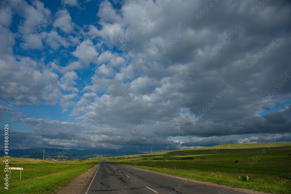 Russia. South Of Western Siberia. Republic Of Khakassia. Picturesque horizons of endless steppes along the highway between the villages of Shira and Uzhur. Russia. South Of Western Siberia. Republic Of Khakassia. Picturesque horizons of endless steppes along the highway between the villages of Shira and Uzhur.
