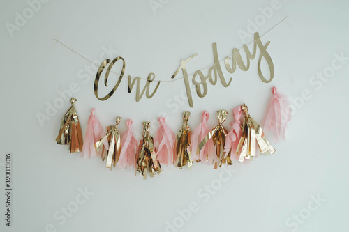 Closeup shot of tassel garland and 'One today' text on the wall