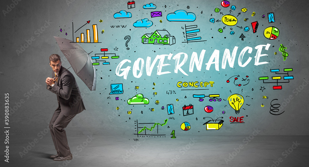 Determined businessman hiding behind umbrella with GOVERNANCE inscription, new business concept Determined businessman hiding behind umbrella with GOVERNANCE inscription, new business concept