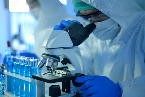 Scientist using microscope during experiment in laboratory, Science and technology healthcare concept