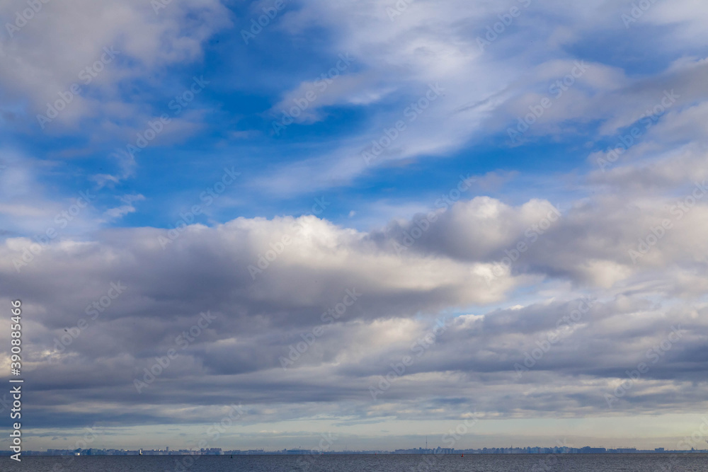background from the blue sky with thick clouds and a line of sea below. background from the blue sky with thick clouds and a line of sea below.