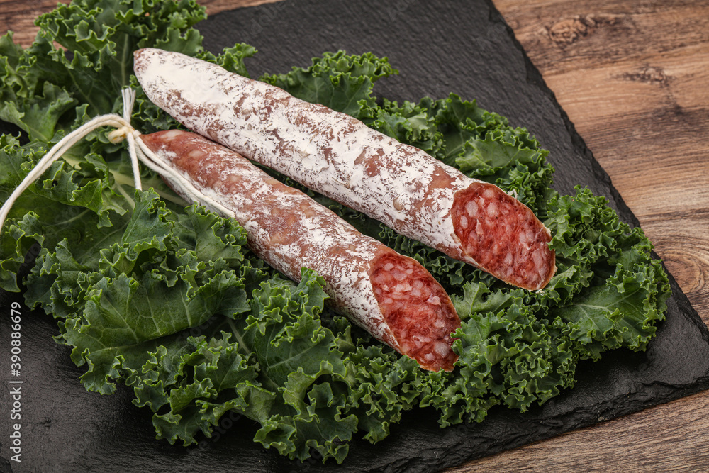 Spanish Fuet sausage with salad leaves Spanish Fuet sausage with salad leaves
