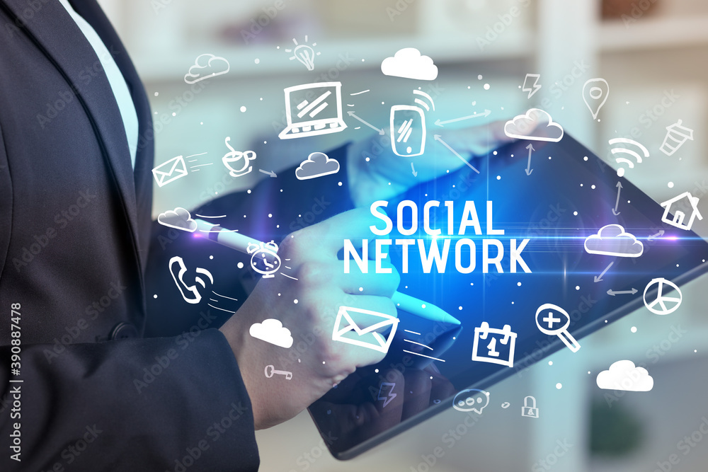 Close-up Of A Person Using Social Networking with SOCIAL NETWORK inscription Close-up Of A Person Using Social Networking with SOCIAL NETWORK inscription
