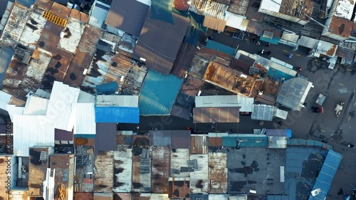 Aerial top down view of the slums and people among them photo