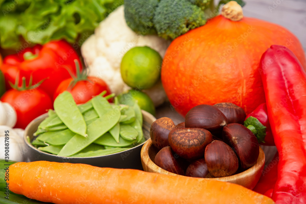 Group vegetables and Fruits Apples, grapes, oranges, and bananas in the wooden basket with carrots, tomatoes, guava, chili, eggplant, and salad on the table.Healthy food concept Group vegetables and Fruits Apples, grapes, oranges, and bananas in the wooden basket with carrots, tomatoes, guava, chili, eggplant, and salad on the table.Healthy food concept
