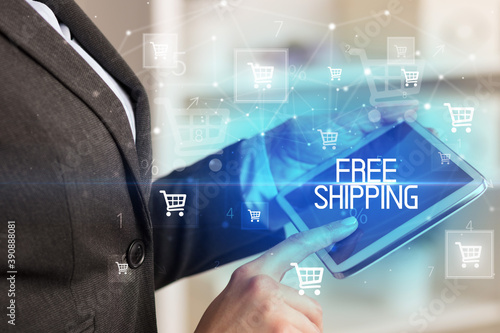 Young person makes a purchase through online shopping application with FREE SHIPPING inscription