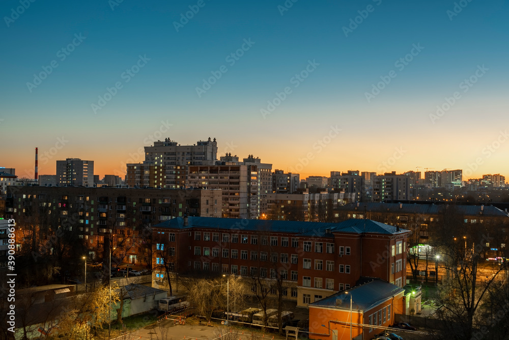 The city is lit by the setting sun. City landscape.