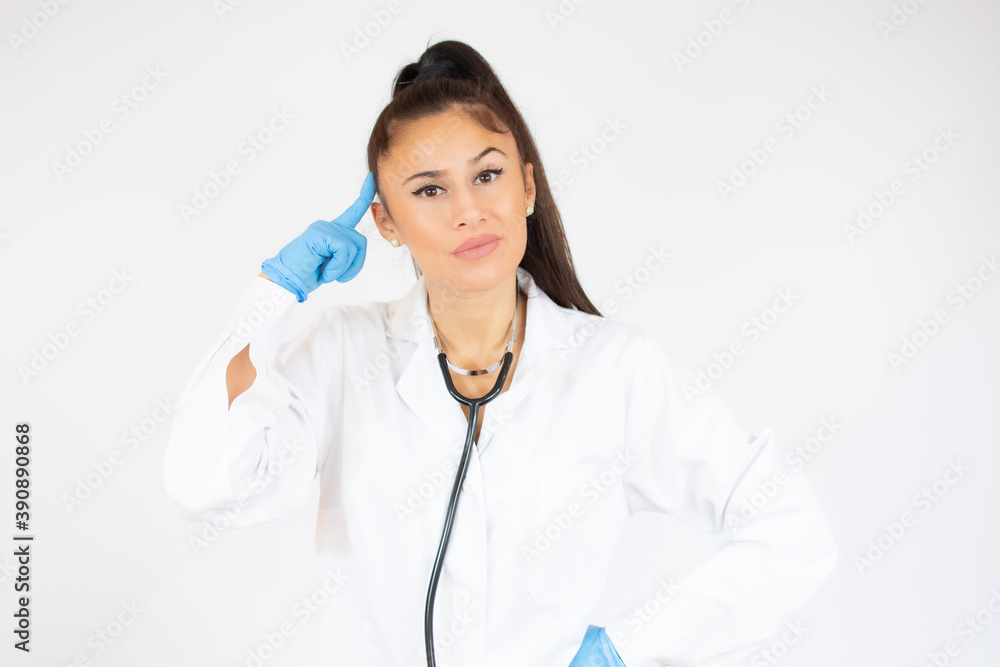 Woman in doctor uniform wearing latex gloves over white background. Woman in doctor uniform wearing latex gloves over white background.