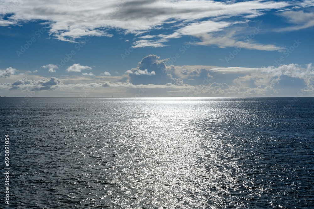 Cloudy blue sky leaving for horizon above a blue surface of the North Sea Cloudy blue sky leaving for horizon above a blue surface of the North Sea