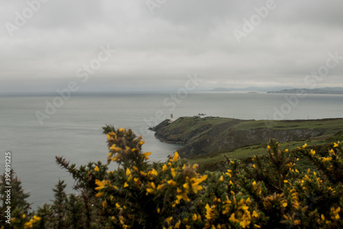 Photography Vertical shot of the Baily Lighthouse in  Dublin Ireland on a gloomy day