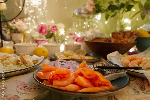 Gourmet smoked salmon, crab salad, and prawns on a romantic table setting