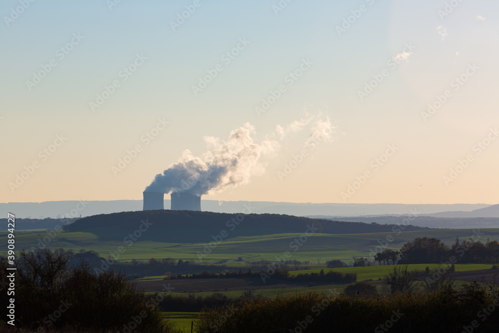 Countryside with nuclear plant cooling towers and vapor