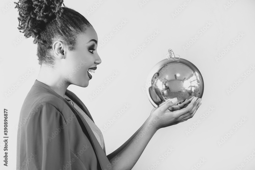 black and white portrait of cheerful afro american woman holding in her hands christmas bauble decoration. Christmas, new year, happiness, holidays concept black and white portrait of cheerful afro american woman holding in her hands christmas bauble decoration. Christmas, new year, happiness, holidays concept