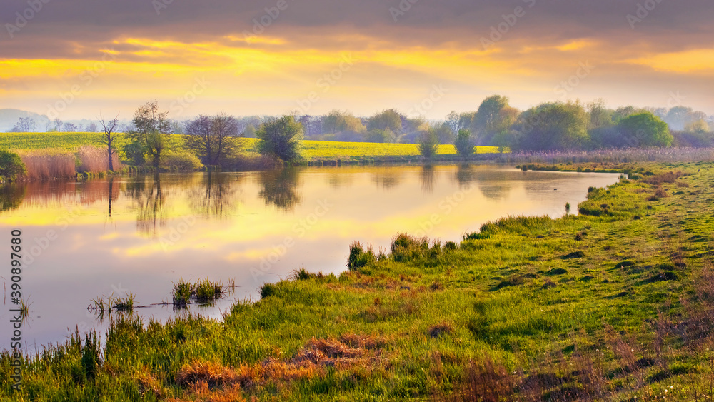 Picturesque spring landscape, sunset on the river, reflection of the sky in the river