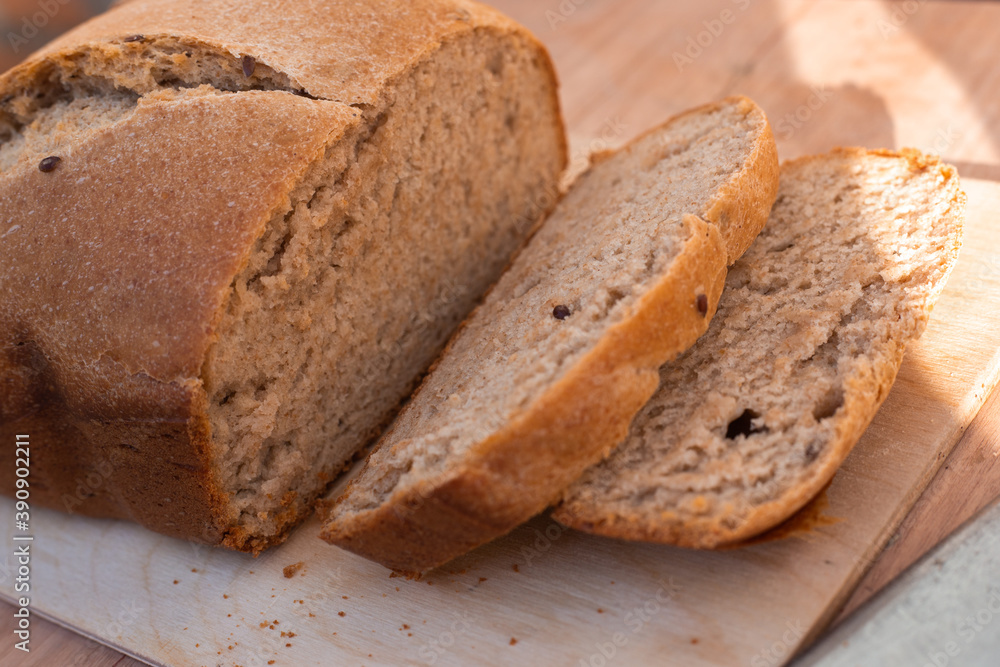 homemade freshly baked whole grain bread with flax seeds in a bread maker.