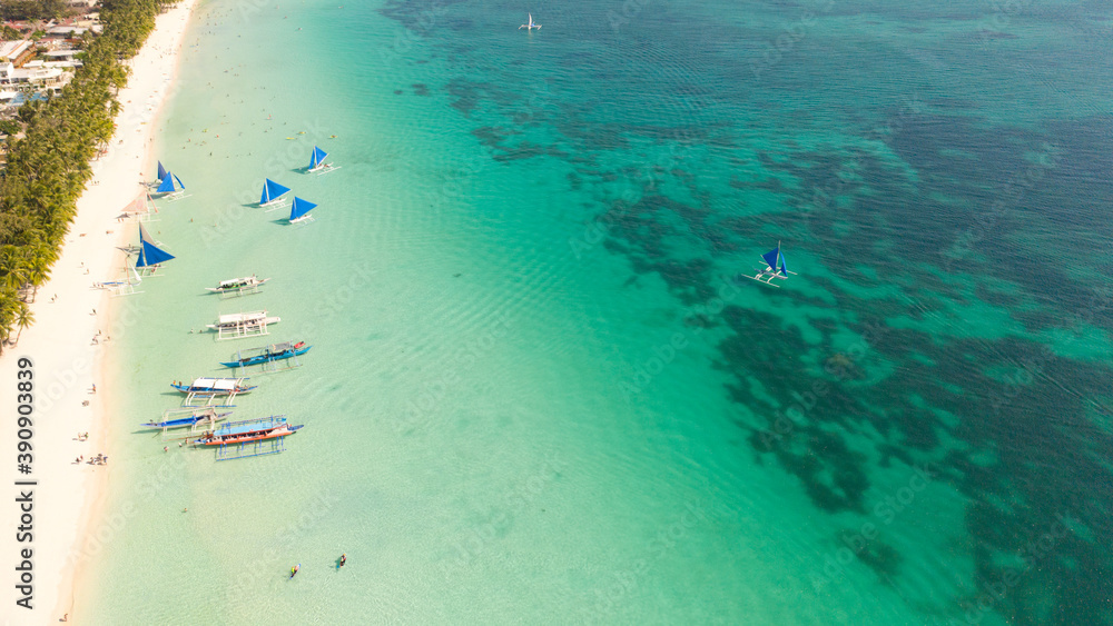 Beautiful lagoon with boats and tourist beach. White beach on the island of Boracay, top view.