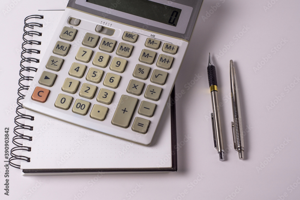 business, education, people and technology concept - close up of with calculator, pen and notebook on table business, education, people and technology concept - close up of with calculator, pen and notebook on table