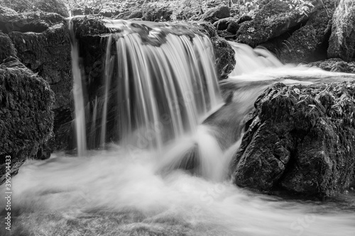 Long exposure of a waterfall on the Hoar Oak Water river flowing through the woods at Watersmeet in Exmoor National Park photo