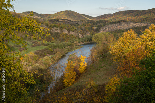 Scenic view of Berounka river and limestone rock formations from a viewpoint in village Tet  n  Czech Republic. Beautiful rolling landscape with colorfull leaves in autumn