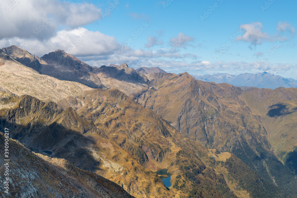 Views from the Sacroux peak (2676m) looking west into the Benasque valley in the Aragonese Pyrenees a blue sky and withe clouds day.