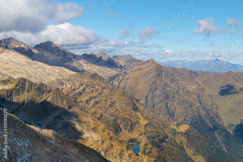 Views from the Sacroux peak (2676m) looking west into the Benasque valley in the Aragonese Pyrenees a blue sky and withe clouds day.