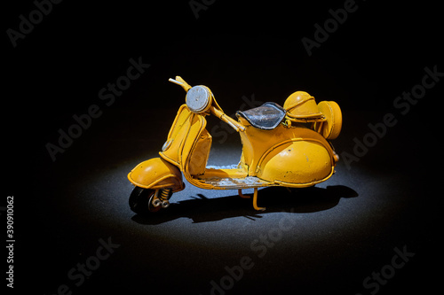 Old toy motorbike on different backgrounds