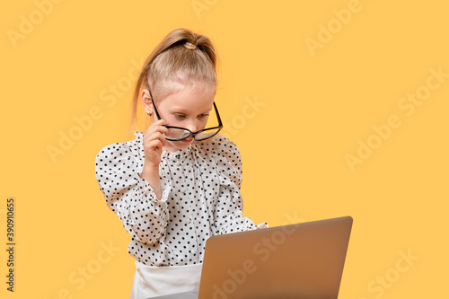 Obraz na plátně The girl is taught at home online using a laptop