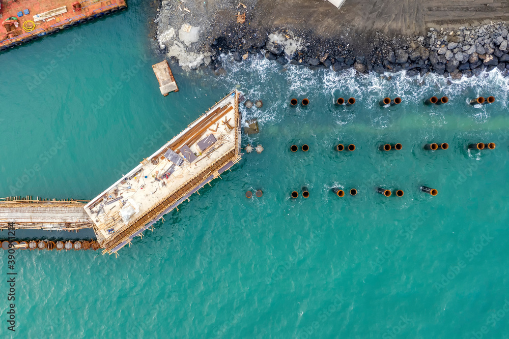 Drone view of a pier construction and piles. Working piers were built for the handling of passengers and cargo onto and off ships or  canal boats.