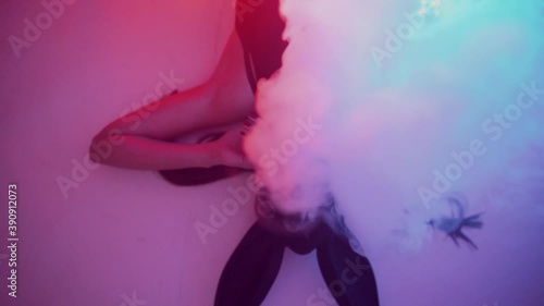 Sexy woman in hare mask posing and gesturing at camera