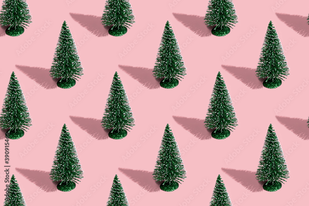 Pattern from Christmas trees on a pink background.