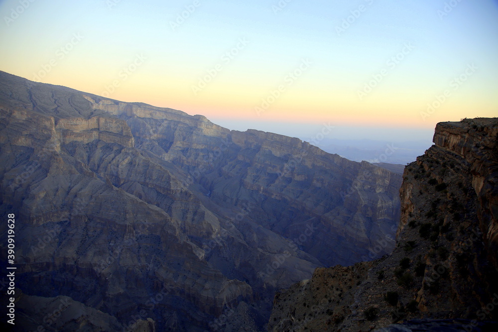 Panorama with contrasting colors of the mountains at sunset, Wadi Ghul the Oman's Grand Canyon, Jabal Akhdar, Sama Heights, Oman
